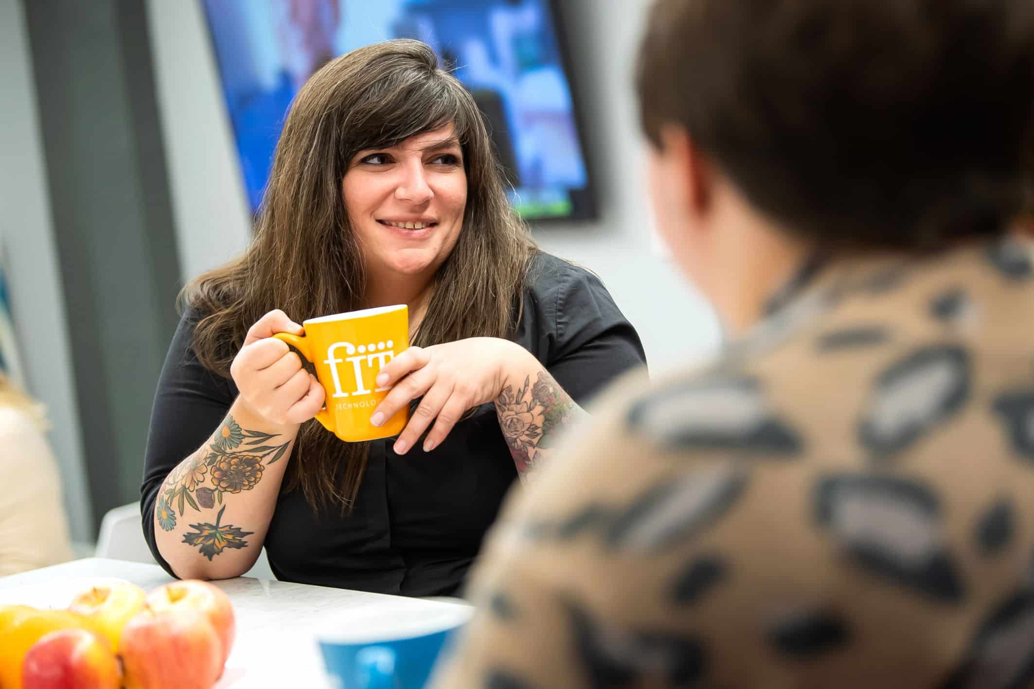 smiling girl holding coffee cup